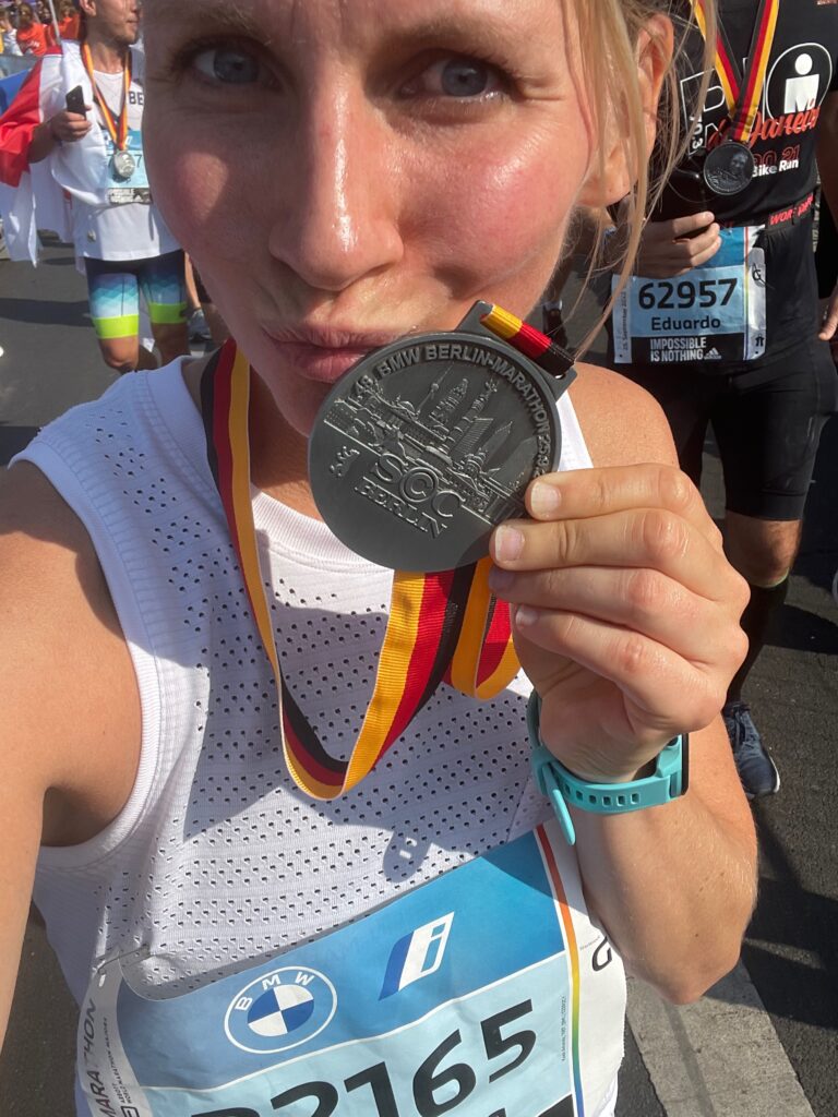 Coach Mandy with her finisher medal at a race